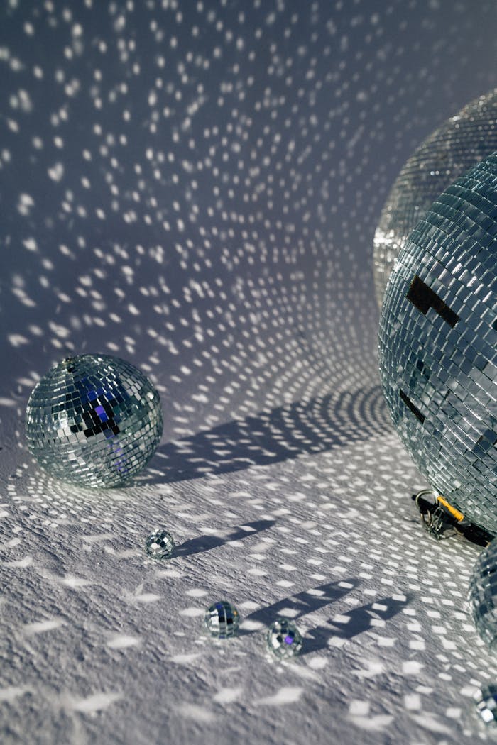 hero-img Close-up of disco balls casting intricate reflections, perfect for party themes.